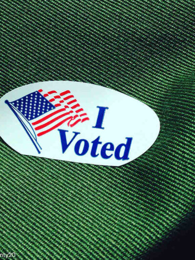 Voting sticker on green fabric