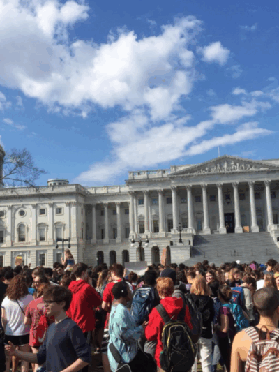 students gather in front of the Capitol for a massive protest