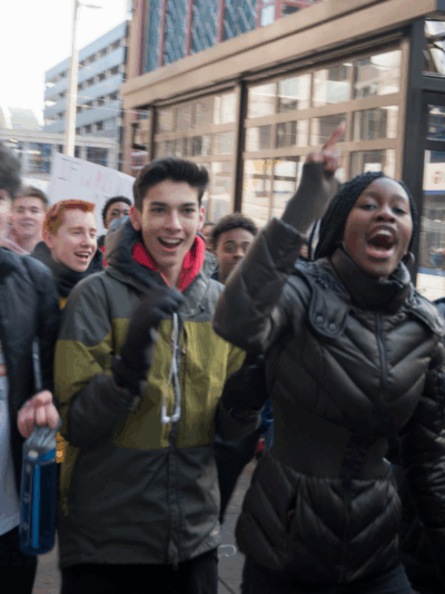 Photo of high school students walking out and protesting