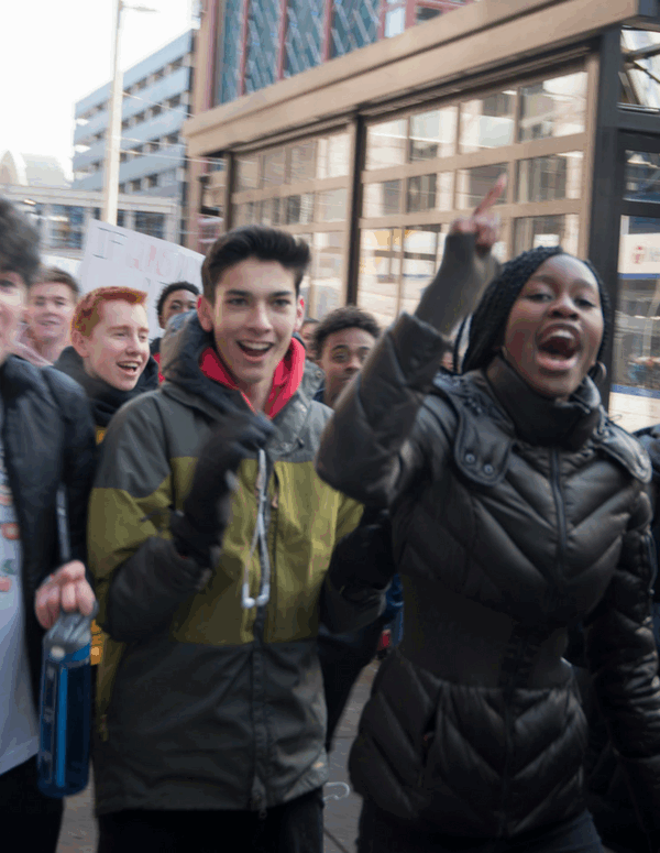 Photo of high school students walking out and protesting
