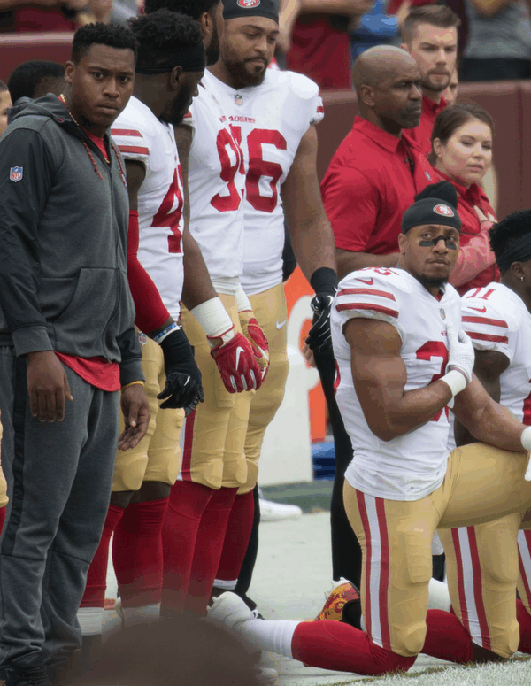 Some members of the San Francisco 49ers kneel during the National Anthem before a game against the Washington Redskins at FedEx Field on October 15, 2017 in Landover, Maryland.