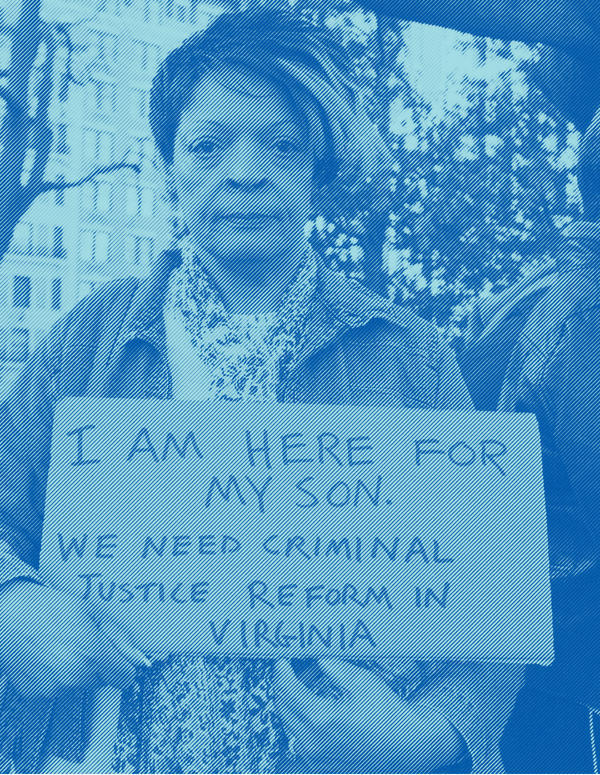 a woman holding a sign that says "I am here for my son. We need criminal justice reform in Virginia"