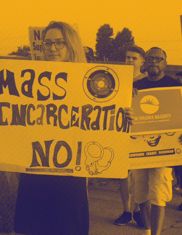 A protester holding sign that says "Mass incarceration No!"