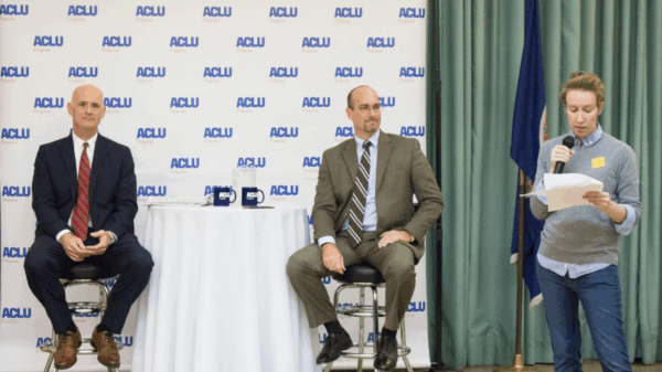 Two candidates for Chesterfield Commonwealth's Attorney in the back with our Director of Advocacy Jenny Glass up front giving an intro at our Commonwealth's attorney candidate forum