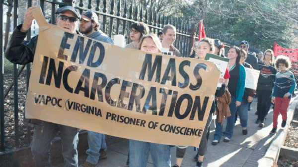 Protesters holding sign that says "End Mass Incarceration - VAPOC Virginia Prisoner of Conscience"