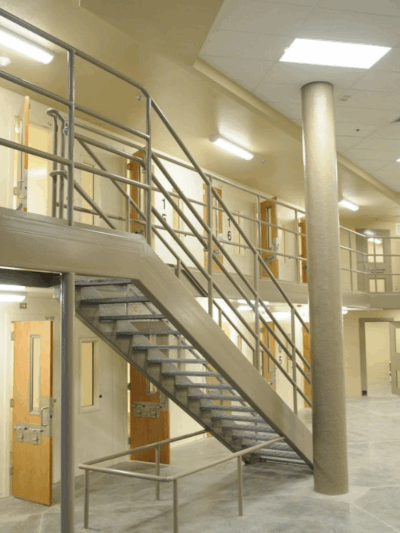 a wide-angle shot of a prison complex, with rows of prison cells