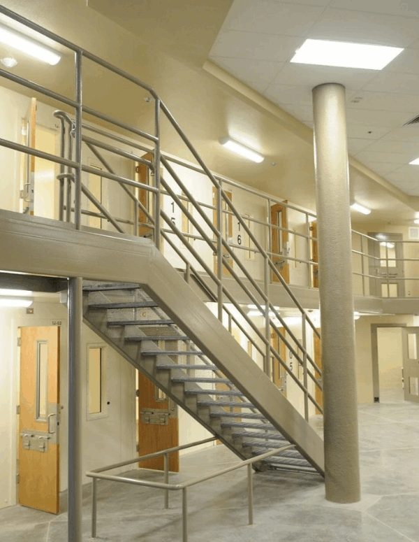 a wide-angle shot of a prison complex, with rows of prison cells