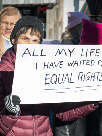 A woman holding a sign that said "All my Life I have waited for equal rights" at the Women's March in Richmond