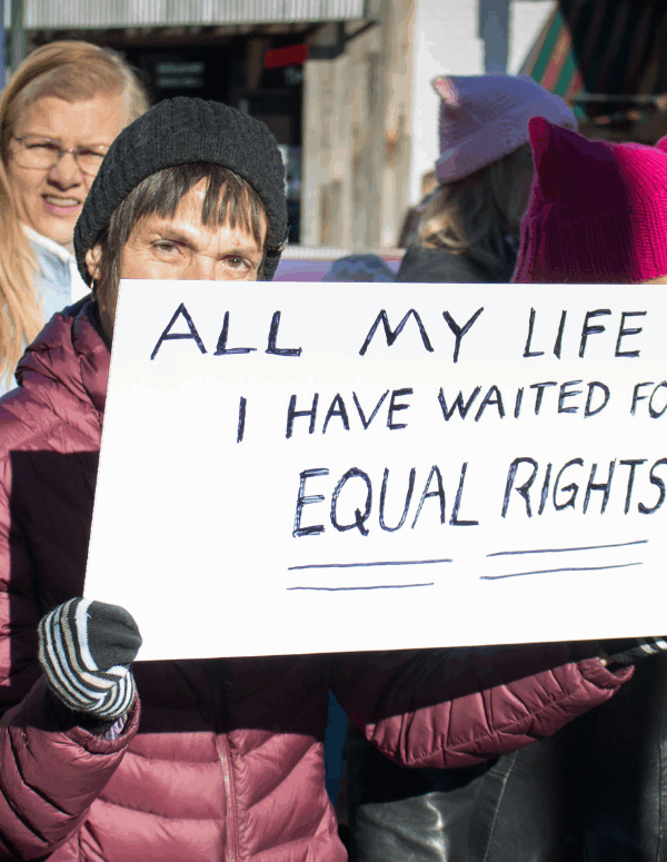 A woman holding a sign that said "All my Life I have waited for equal rights" at the Women's March in Richmond