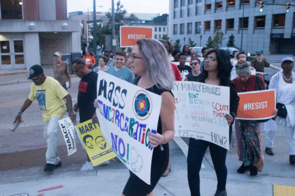 A woman protester holding a sign that says "Mass Incarceration NO!"