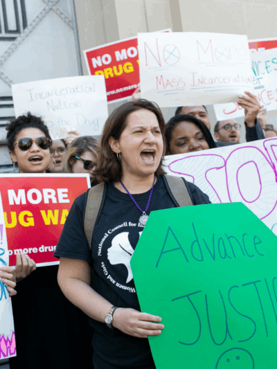 protesters holding signs with pro-criminal justice reform messages