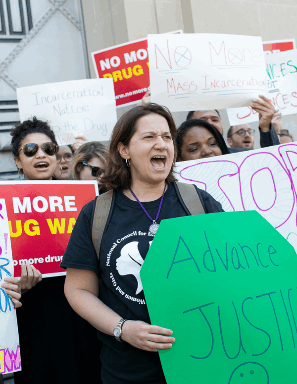 protesters holding signs with pro-criminal justice reform messages