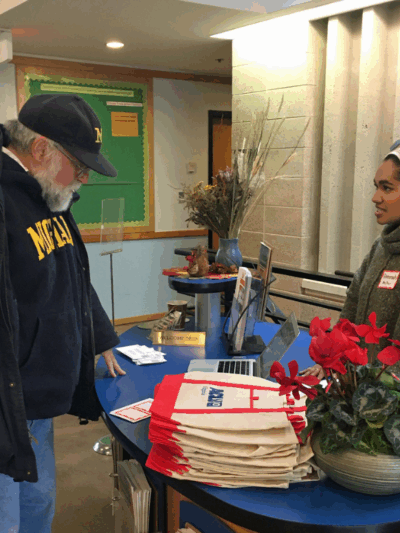 Our intern Ameenah in her hijab at the reception table greeting guests at our 2020 Legislative forum