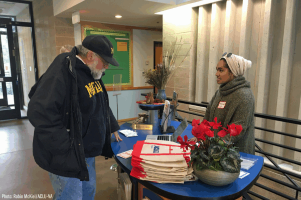 Our intern Ameenah in her hijab at the reception table greeting guests at our 2020 Legislative forum