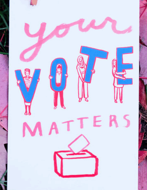 A protest sign that says "Your Vote Matters" against a background of red maple leaves