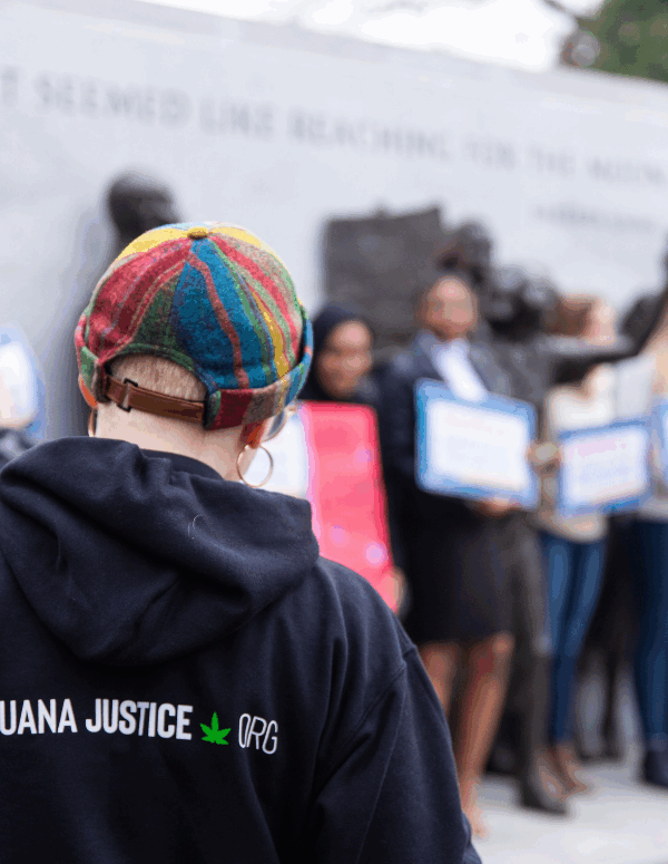 a protester wearing a hoodie with Marijuana Justice logo on