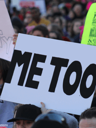 People carrying sign that says "Me Too"