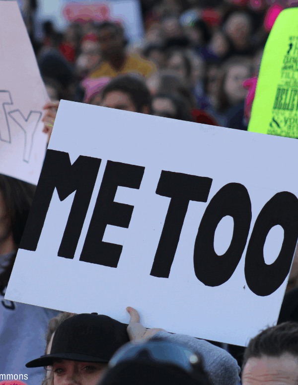 People carrying sign that says "Me Too"