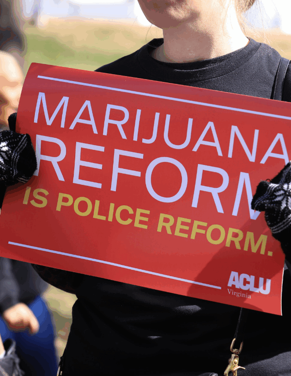 a red protest sign that says "marijuana reform is police reform"