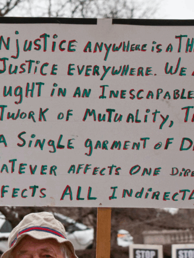 a sign quoting Martin Luther King "injustice anywhere is a threat to justice everywhere..."