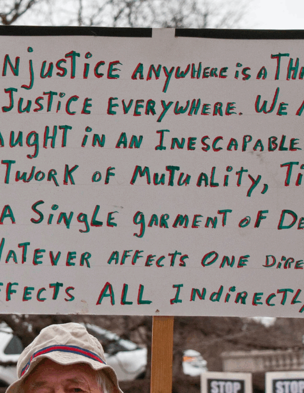 a sign quoting Martin Luther King "injustice anywhere is a threat to justice everywhere..."