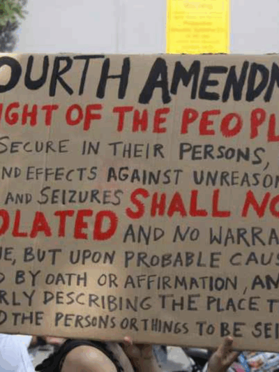 a protest sign with the fourth amendment written out on it