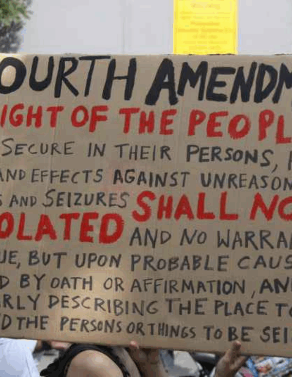 a protest sign with the fourth amendment written out on it