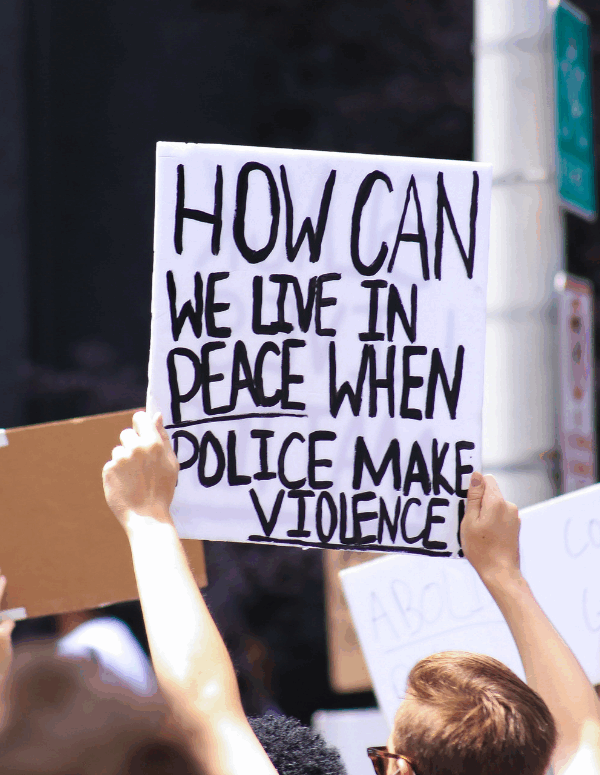 a protest sign with the text "how can we live in peace when police makes violence"