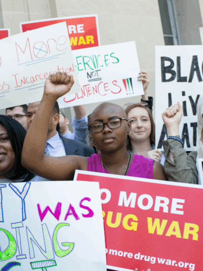 A diverse group of Black women, Muslim women, Latina women, and white women protesting the War on Drugs and its impact on women