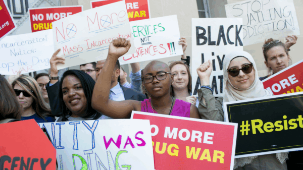 A diverse group of Black women, Muslim women, Latina women, and white women protesting the War on Drugs and its impact on women