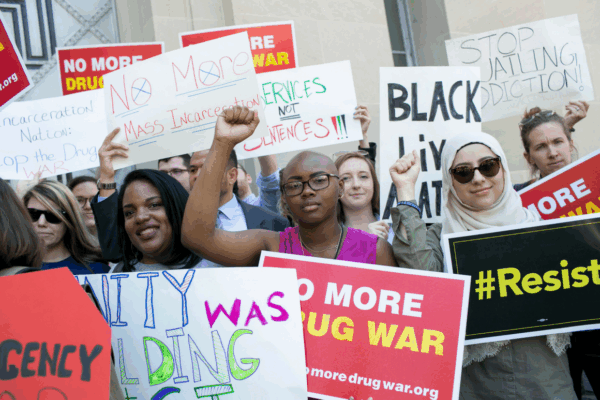 A diverse group of Black women, Muslim women, Latina women, and white women protesting the War on Drugs and its impact on women