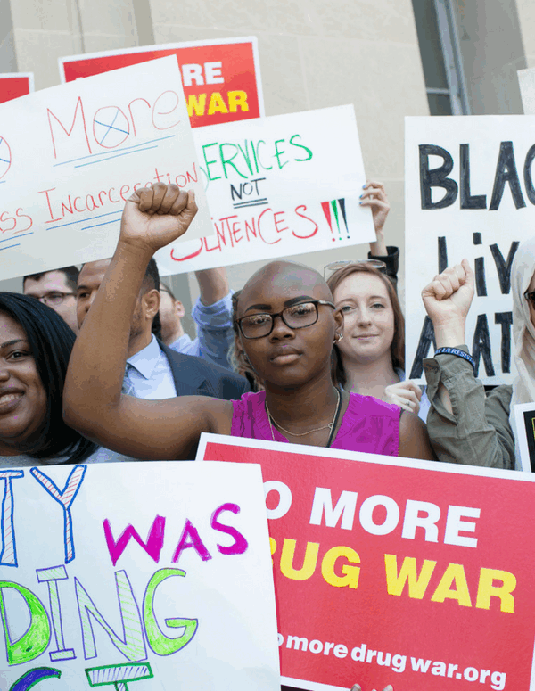 A diverse group of Black women, Muslim women, Latina women, and white women protesting the War on Drugs and its impact on women