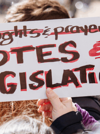photo of a protest sign with the text "Votes & Legislation"