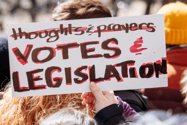 photo of a protest sign with the text "Votes & Legislation"