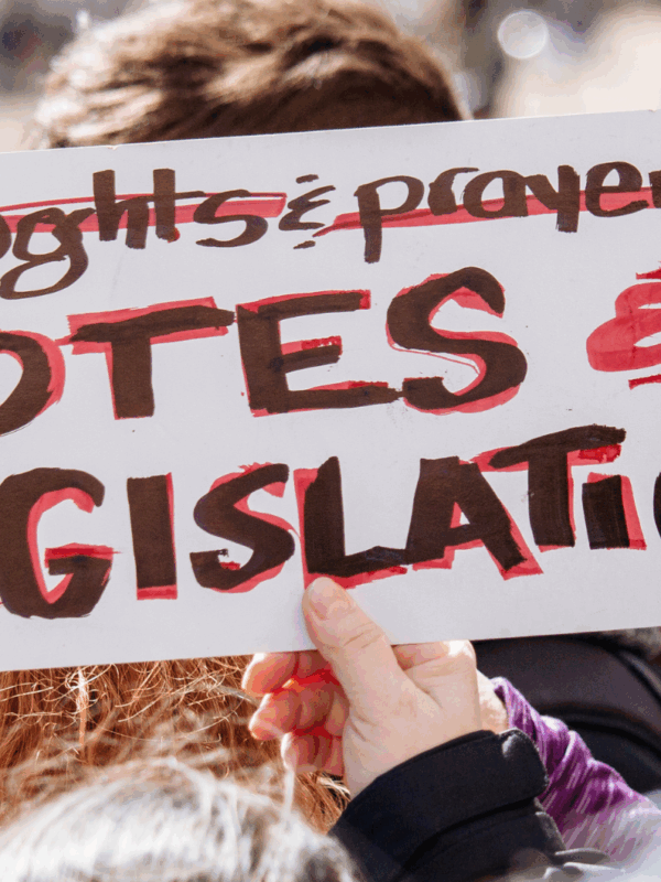 photo of a protest sign with the text "Votes & Legislation"