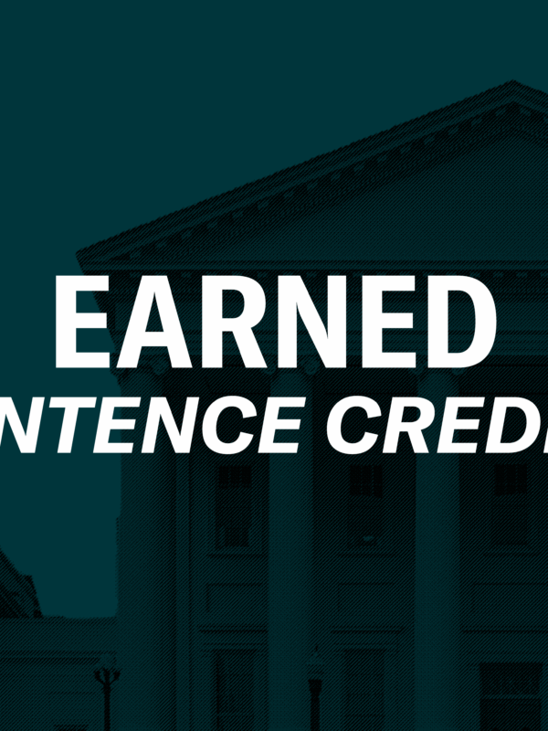Over a a dark green background of the Virginia state capitol is a person embracing a recently returned Virginian in a hug. To the right of the graphics is a black gavel. In the middle of the graphic is text, "Earned sentence credits."