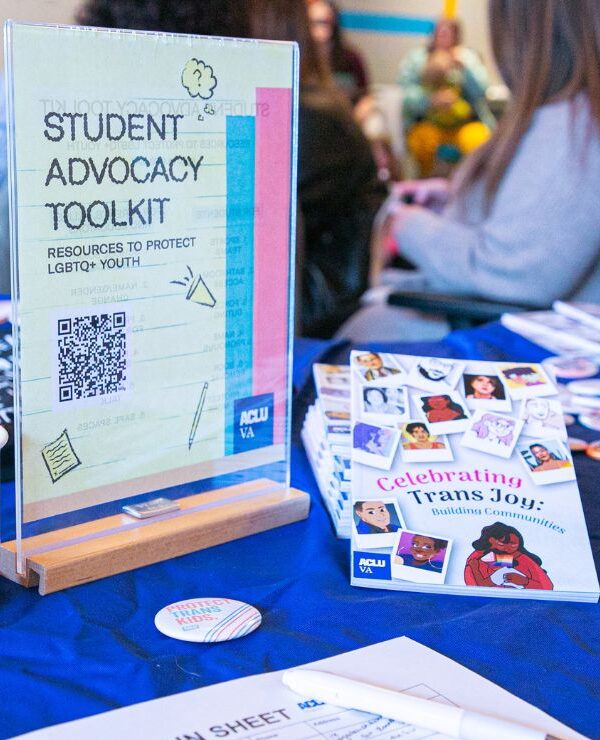 ACLU-VA table with many trans joy zine, buttons, stickers, and resources for LGBTQ+ students