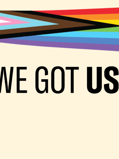 A pride inclusive rainbow over a light yellow background.