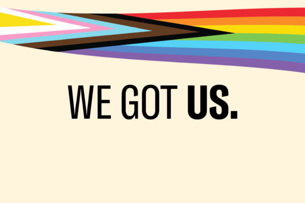 A pride inclusive rainbow over a light yellow background.