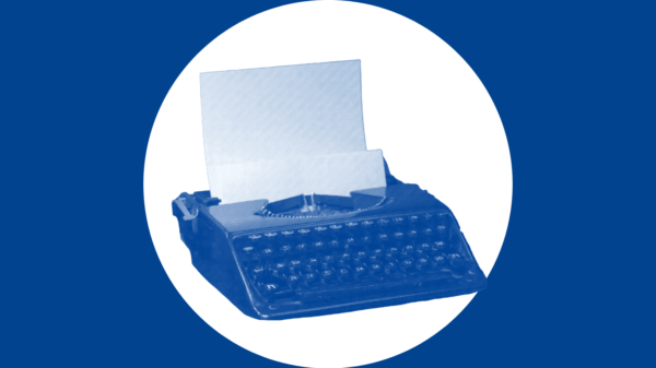 Over a navy background is a white circle with a navy typewriter in the middle.