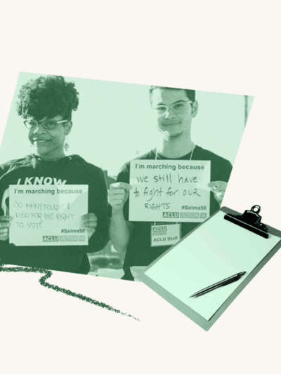 Two people in green holding up signs with a clip board over top.