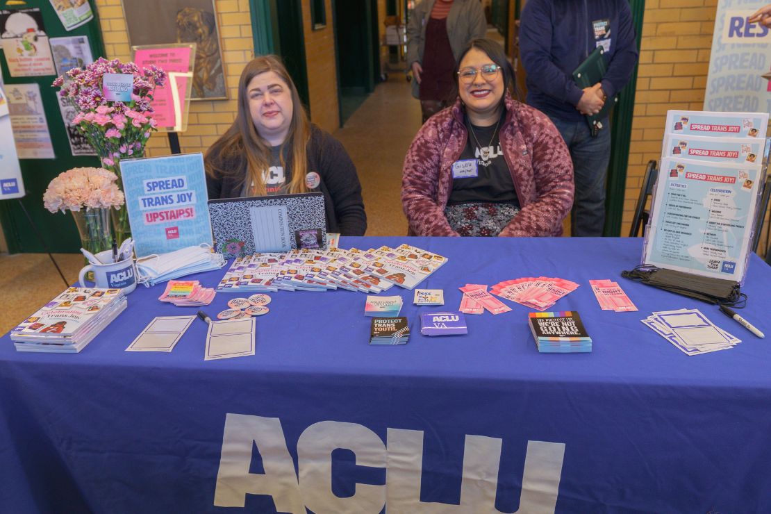 ACLU-VA Organizer and a volunteer sat at the ACLU-VA table full of swag and literature