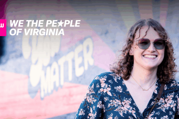 A woman faces towards a camera smiling, in front of a mural. In the top right corner is a logo that says "ACLU of Virginia We the People of Virginia."