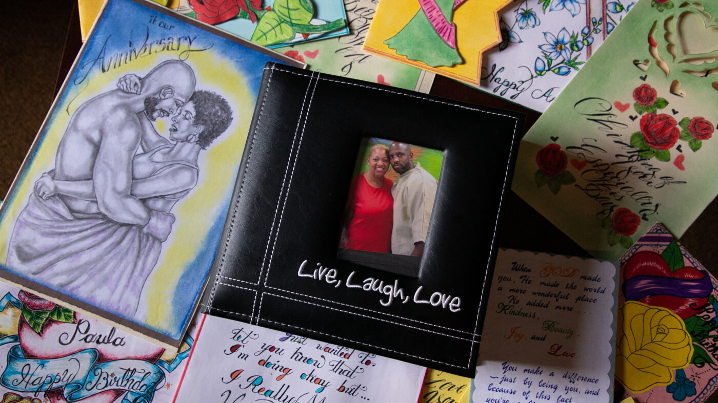 A photo album of Paulettra and Jerry surrounded by handmade cards sent to Paulettra from prison