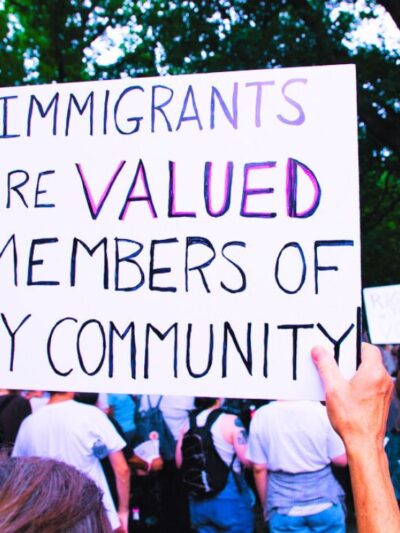 protest sign with the message "immigrants are valued members of my community."
