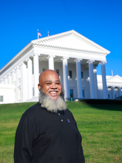 Tati smiles ear to ear with the Virginia Capitol in the background