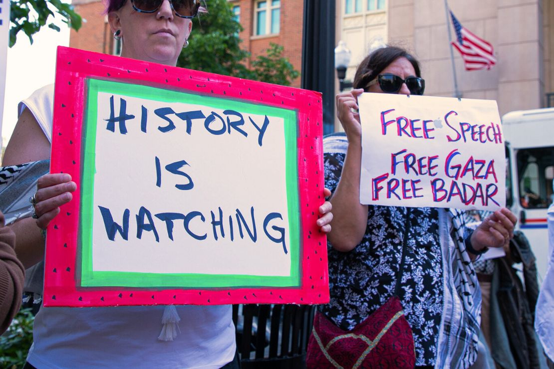 Protesters carry signs with message like "History is Watching" and "Free speech, free Gaza, free Badar"