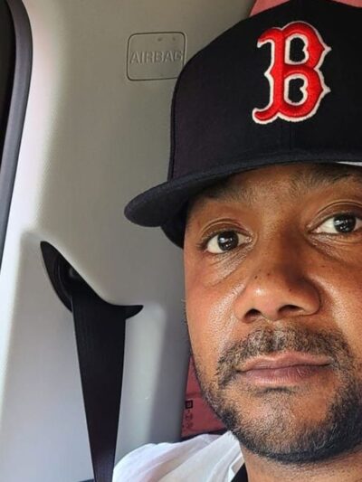 Sincere, wearing a Boston Red Sox, smiled warmly at the camera