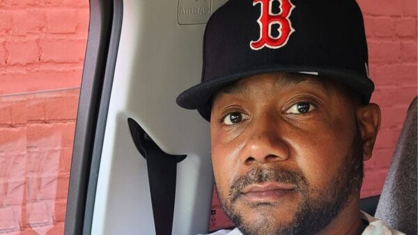 Sincere, wearing a Boston Red Sox, smiled warmly at the camera