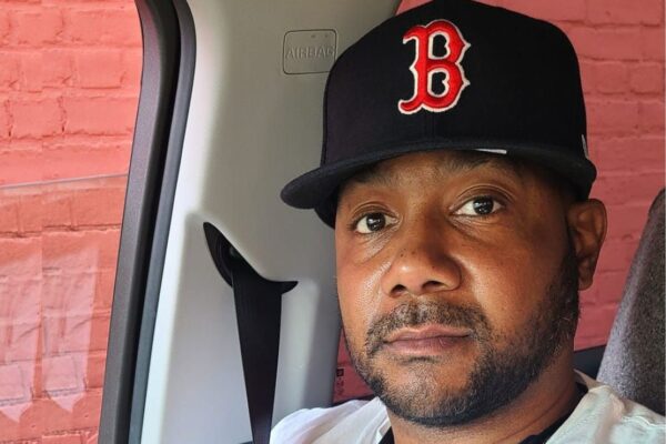 Sincere, wearing a Boston Red Sox, smiled warmly at the camera